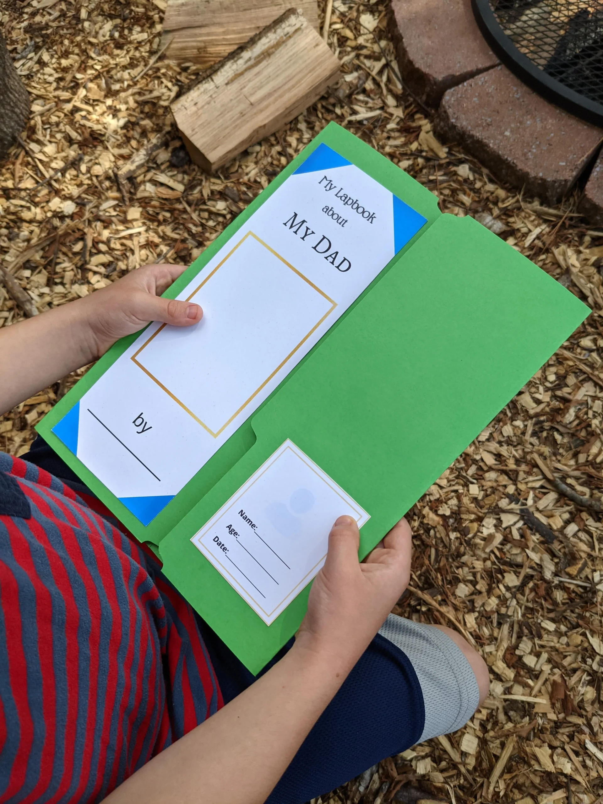all about Dad lapbook cover with child holding the lapbook