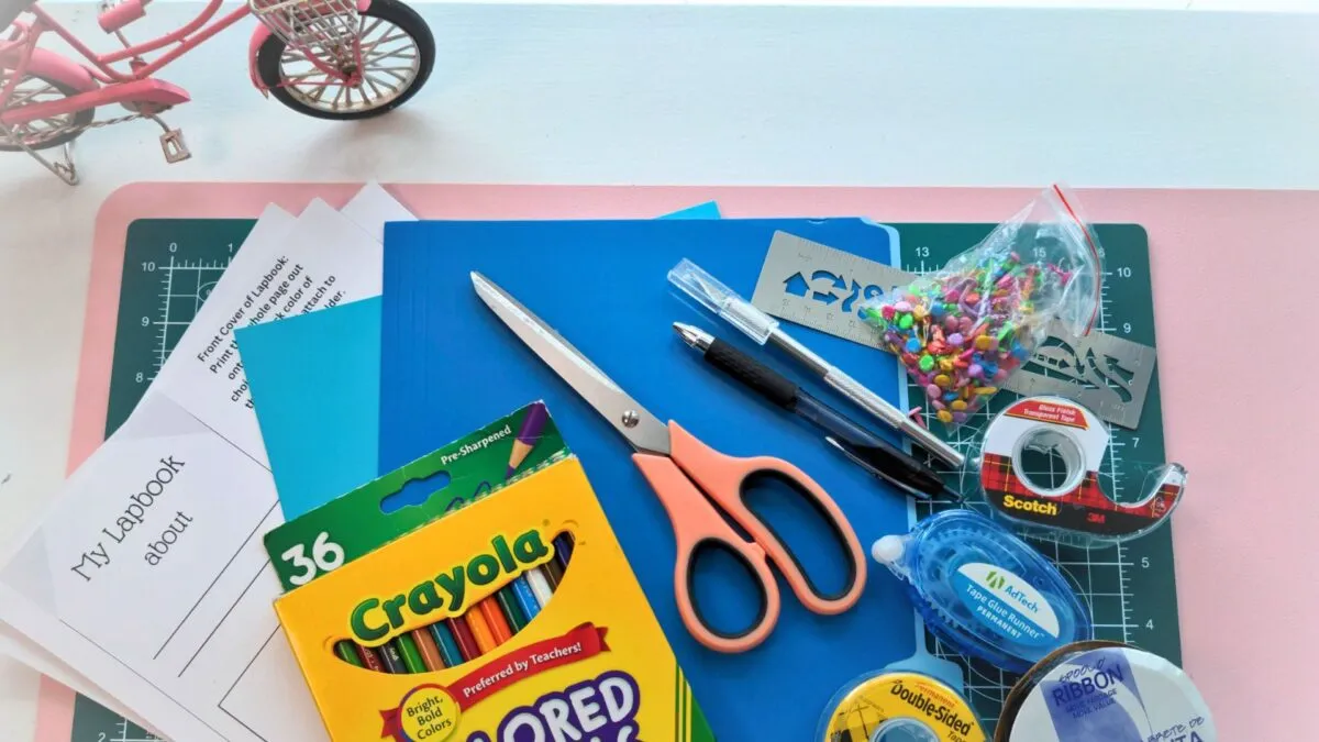 lapbook cover image with several craft tools and paper in flat lay photo